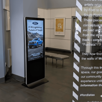 Digital welcome sign for car dealerships greeting customers by name with appointment details.